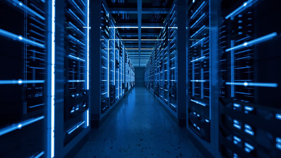 A data centre illuminated by blue lighting.